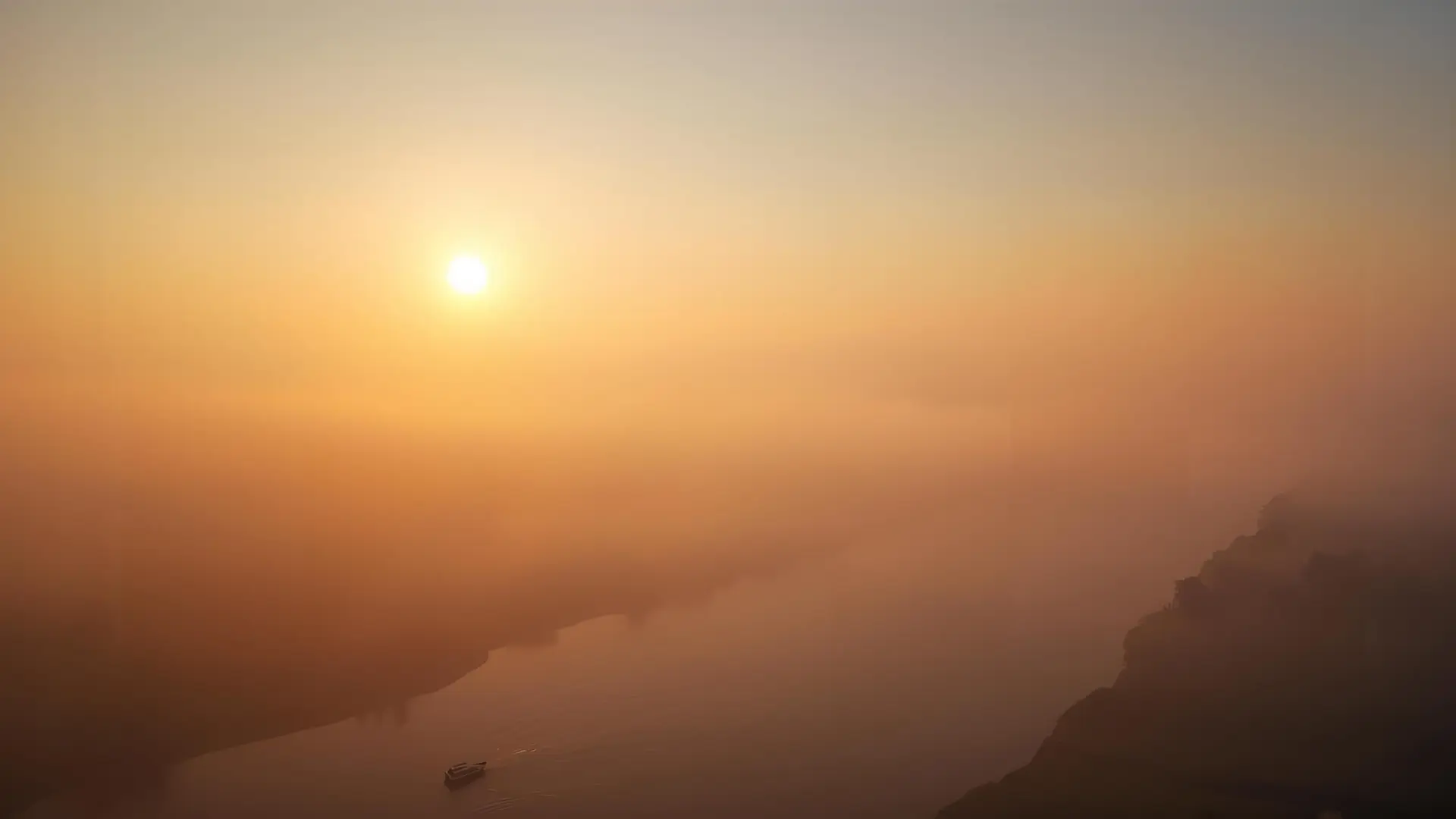 morning sun, low fog over a river covering the sun, barely visible boat - still and grounding.